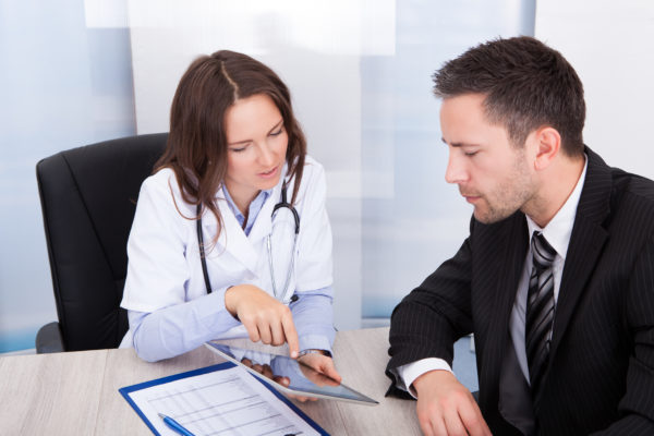 Female Doctor Showing Digital Tablet Closed Loop Marketing Pharma Associates Looking at Tablet