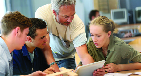 People Gathered Around Digital Asset Management System Tablet