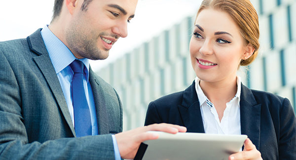 Sales and Content Marketing Professionals Looking at Tablet