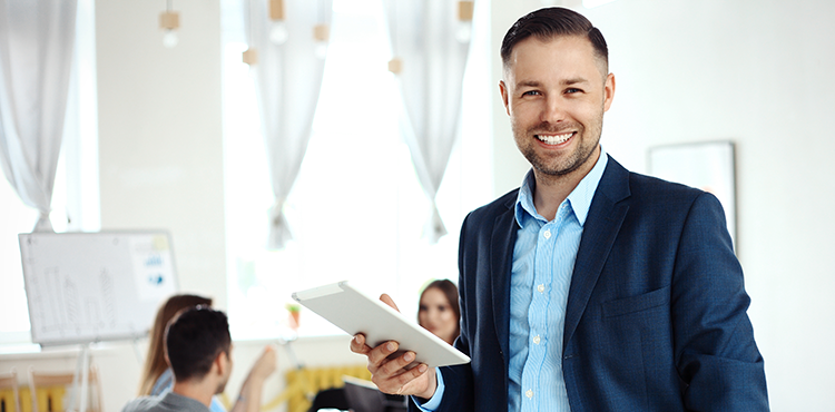 Smiling Person Holding Sales Enablement Software Tablet